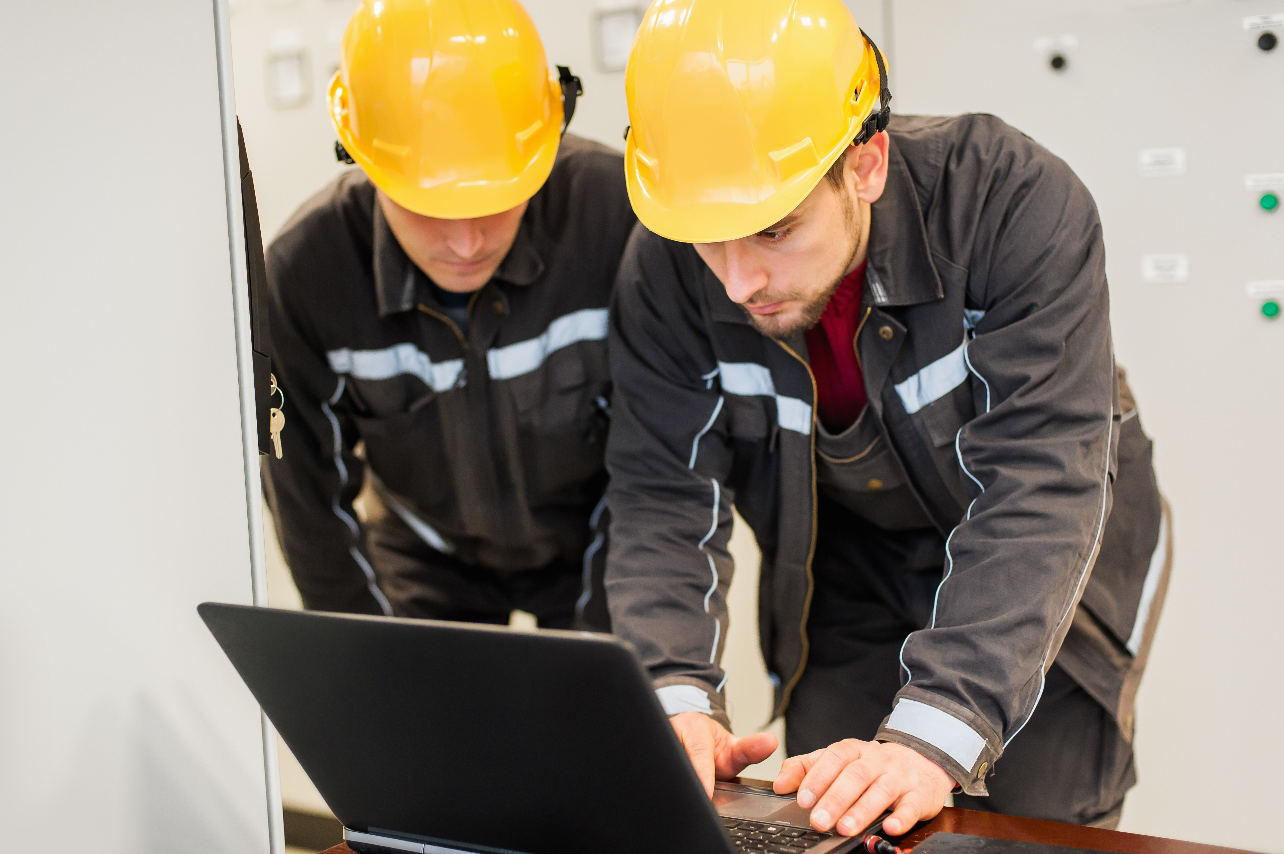 Field Service showing 2 engineers in hard hats at a laptop